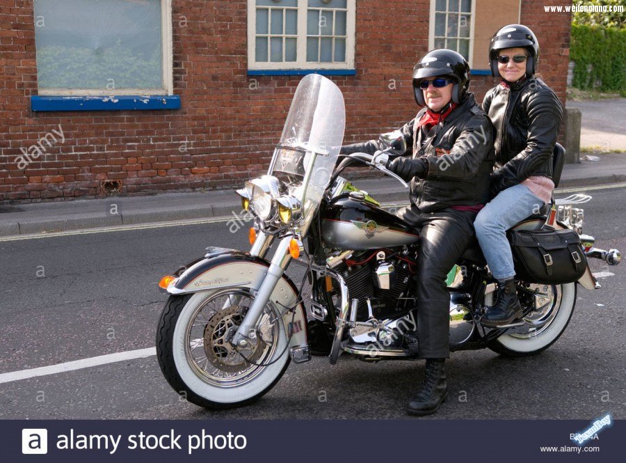 couple-riding-a-harley-davidson-motorcycle-gosport-hampshire-uk-BB124A.08.jpg